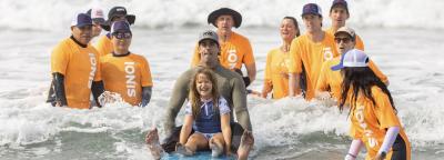 Ionis volunteers with a child parrticipant during Surfaway 